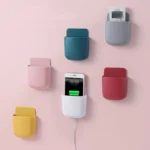 "Wall-mounted phone and remote holder storage box for smartphones, remote controls, and accessories"