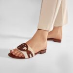 A pair of casual, wide-strap slides, inspired by Ralph Lauren, shown in either black or brown on a clean background.