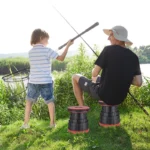 Compact, portable telescopic folding stool/chair, shown fully extended and ready for use as a space-saving seat for camping or fishing.