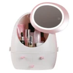 Rechargeable makeup mirror with a dimming LED light ring, sitting on a round cosmetic storage box base, showing its spin or rotating function for a portable vanity setup.