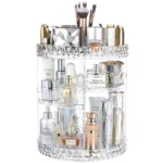 Clear acrylic $360^\circ$ rotating cosmetic organizer filled with various makeup brushes, perfumes, and skincare products, showing its adjustable multi-tiered design.