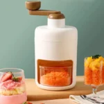 Manual hand-crank ice crusher machine with a visible collection mold/cup, showing its commercial-grade housing and mechanism for making crushed or shaved ice.